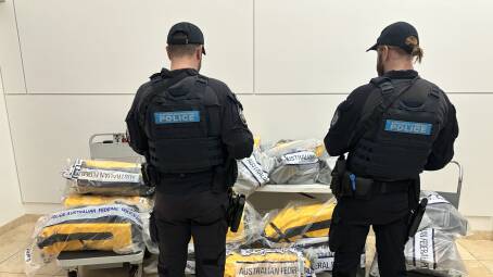AFP officers pictured with the 500 kilogram haul of seized drugs. Pictures suppled.