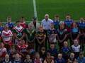 Knights CEO Phil Gardner and Hunter Junior Rugby League chair Bob Dixon with players at McDonald Jones Stadium on Thursday. Picture by Jonathan Carroll