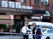 Police at the Commonwealth Hotel after last month's armed robbery. Picture by Peter Lorimer
