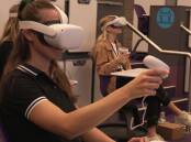 University of Newcastle students try out the speech pathology virtual reality program. Picture supplied